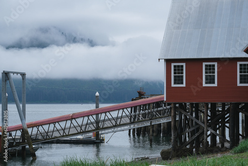 Old cannery in Hoonah, Icy Strait Point Alaska for canning fresh Fish and now serving as cruise travel destination wildlife adventure for tours, kayaking, whale and bird bear watching nature scenery