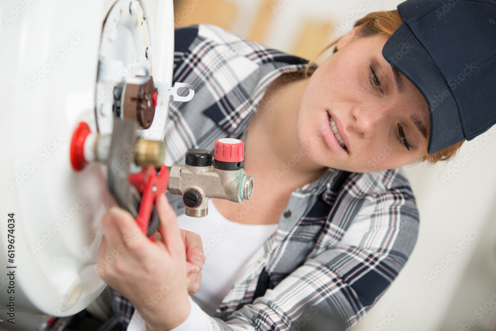 young woman following instructions to set up boiler