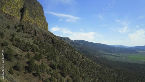 Lush Green Slope Of Abert Rim - Majestic Landmark In Lake County, Oregon With Breathtaking Scenery. aerial descend photo