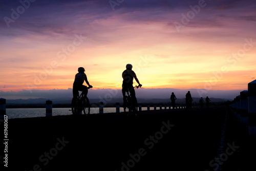 Silhouette of cyclist biking at the sunset