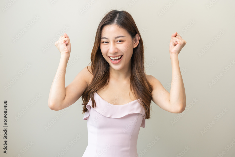Smiling positive, attractive asian young woman wearing beautiful pink dress, portrait of female brunette hair with long hair. Cheerful girl expression face happy standing isolated on white background. Smiling positive, attractive asian young woman wearing beautiful pink dress, portrait of female brunette hair with long hair. Cheerful girl expression face happy standing isolated on white background.