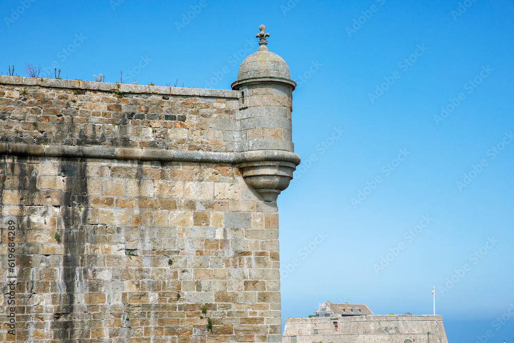 St Malo, France. View over the walled city Saint-Malo medieval pirate fortress, St Vincent Cathedral and lighthouse from the sea in Summer Daytime, Brittany