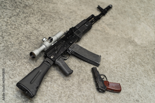 Russian weapon, ak assault rifle with optical sight and pm.