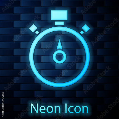 Glowing neon Stopwatch icon isolated on brick wall background. Time timer sign. Chronometer sign. Vector