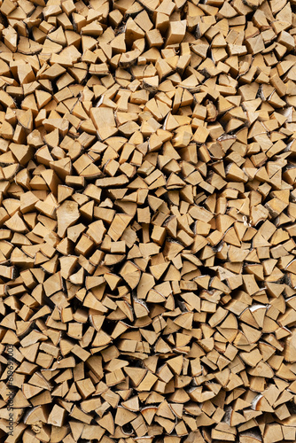 Woodpile with chopped wood for heating the house and lighting a fire