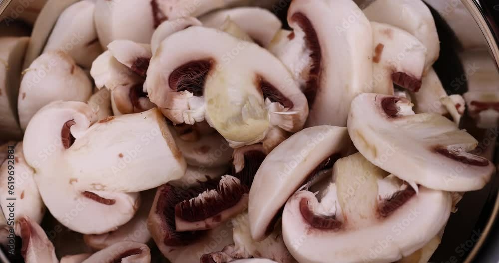 sliced mushrooms during cooking dishes with champignons, white edible mushrooms sliced and washed sliced mushrooms during cooking dishes with champignons, white edible mushrooms sliced and washed