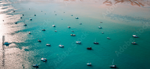 ฺBoats and yachts on the beach as the sun shines on the surface of the water. © Jitti