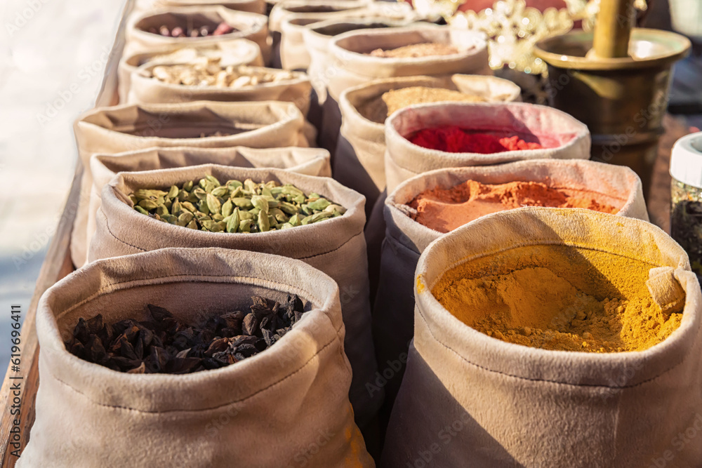 Fototapeta premium Bags of mixed spices in the street market. Colorful detail of Central Asia travel. Bukhara, Uzbekistan