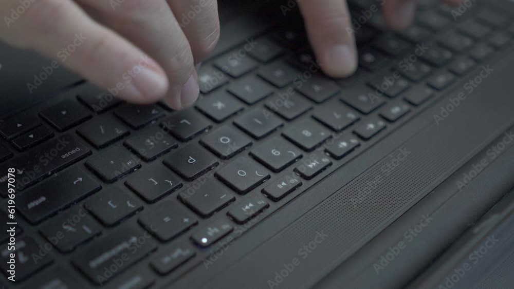 Close-up of the hands of a man typing on a laptop. Close-up of the hands of a man typing on a laptop.