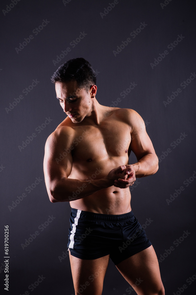 Muscular and torso of young man having abs, bicep and chest. Male hunk with athletic body.