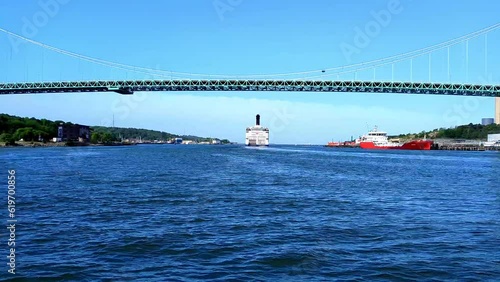 A ferry passes under the Alvsborgsbron bridge in Gothenburg, Sweden. Locked shot photo