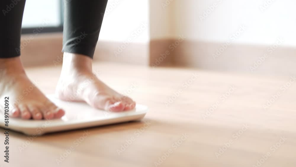 Woman feet standing on weigh scales, diet concept. Woman feet standing on weigh scales, diet concept.