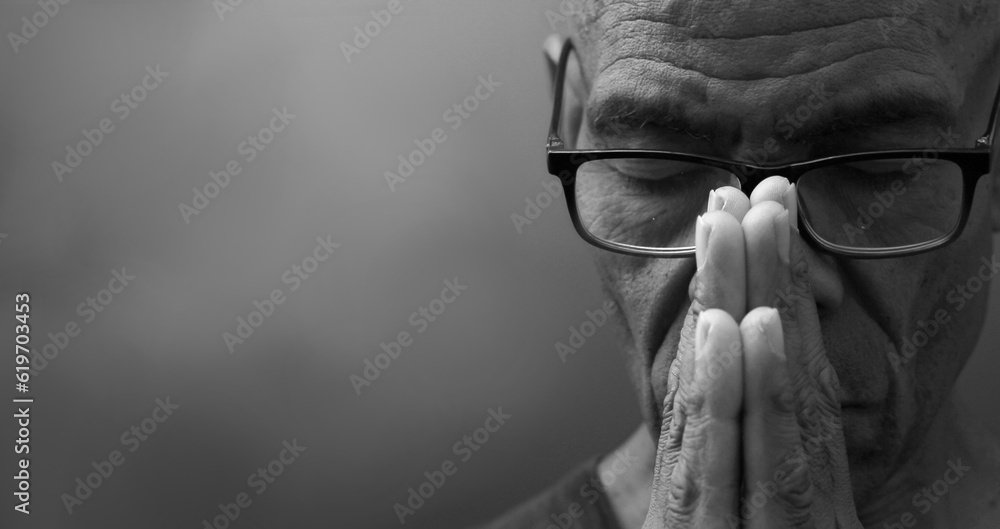 man praying to god with prayer with devotion Caribbean man praying on black background with people stock photos stock photo	
