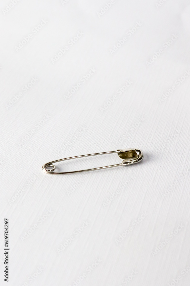 a single pin on white background. Safety Pin for blanket with standard size. isolated on white background a single pin on white background. Safety Pin for blanket with standard size. isolated on white background