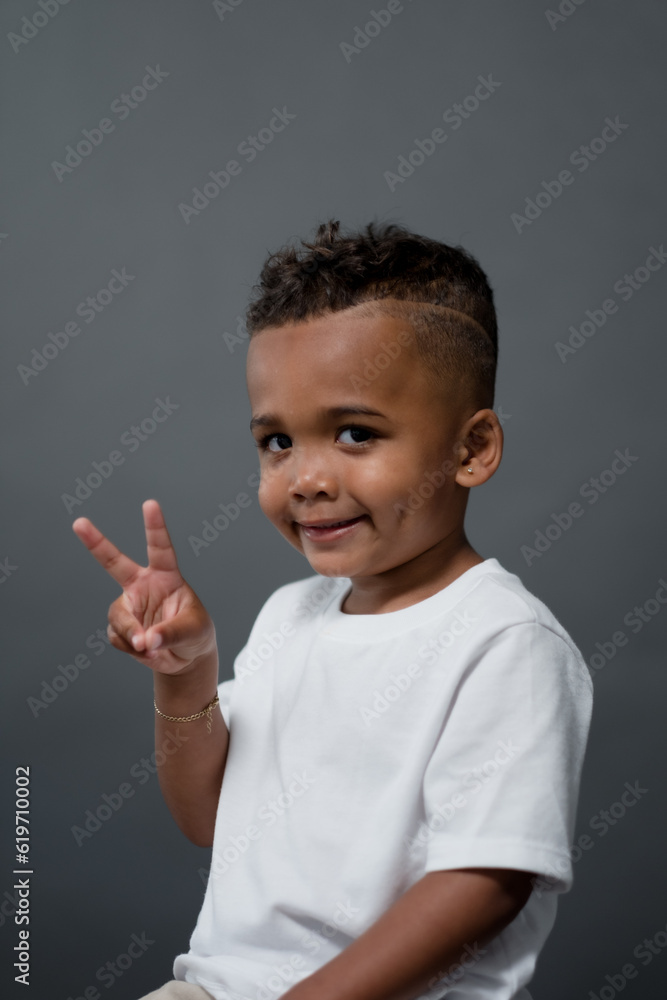 Wish a sheepish grin, a toddle gives a two-finger peace sign. Wish a sheepish grin, a toddle gives a two-finger peace sign.