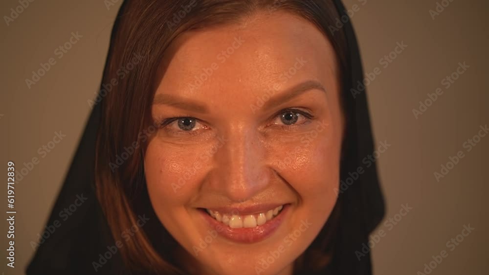a woman in a hood looks at the camera. candles and pumpkin. close-up. woman flirting. holiday Halloween. slow motion video. High quality Full HD video recording a woman in a hood looks at the camera. candles and pumpkin. close-up. woman flirting. holiday Halloween. slow motion video. High quality Full HD video recording