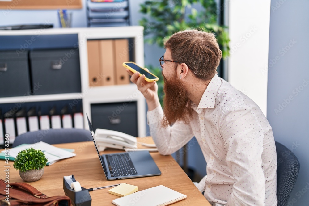 Young redhead man business worker talking on smartphone working at office Young redhead man business worker talking on smartphone working at office
