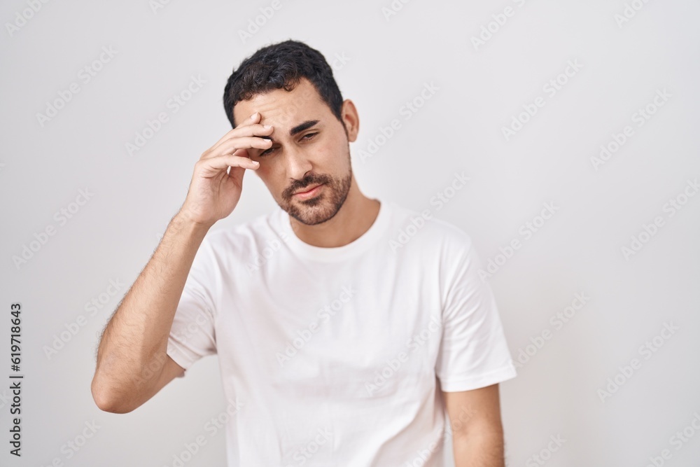 Handsome hispanic man standing over white background worried and stressed about a problem with hand on forehead, nervous and anxious for crisis Handsome hispanic man standing over white background worried and stressed about a problem with hand on forehead, nervous and anxious for crisis