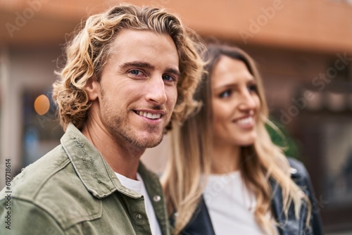 Man and woman couple smiling confident standing together at street