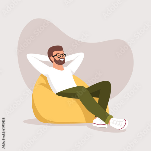 a man sleeps (rests) in a bean bag chair