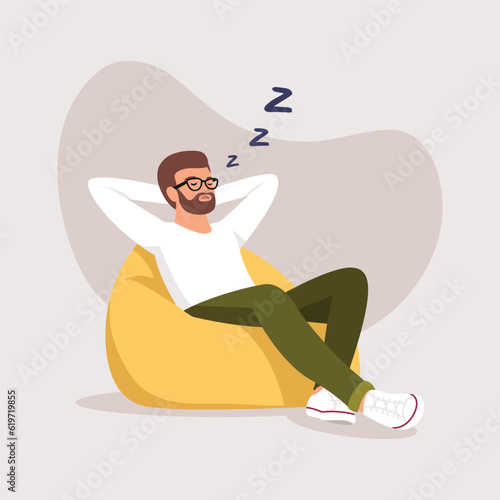 a man sleeps (rests) in a bean bag chair