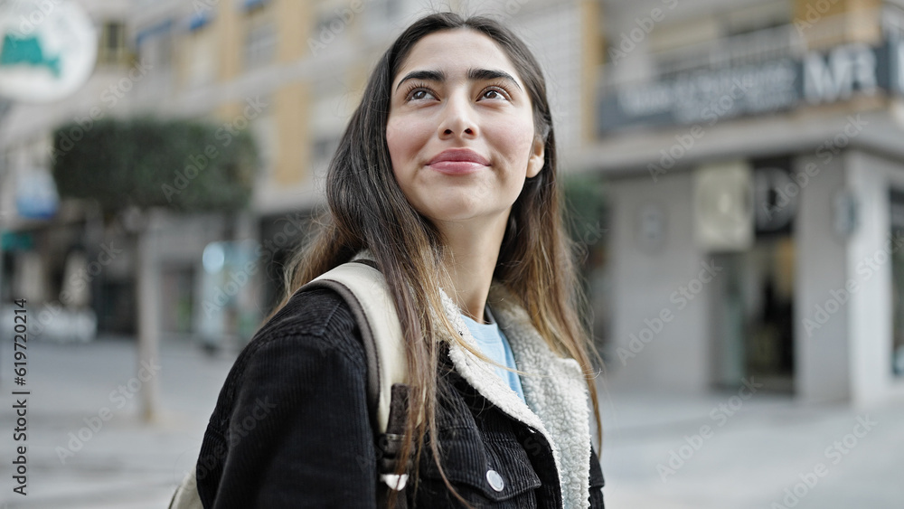 Young beautiful hispanic woman student smiling confident standing at street