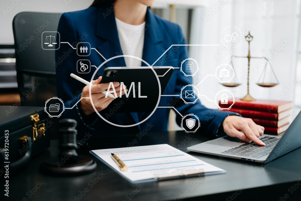 Naklejka premium AML Anti Money Laundering Financial Bank Business Concept. judge in a courtroom using laptop and tablet with AML anti money laundering icon on virtual screen. .