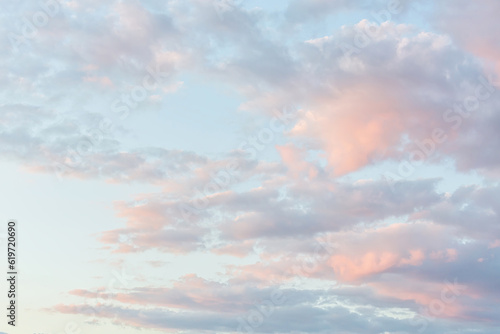 Beautiful fluffy clouds painted in pastel colors at sunrise. Multicolor background or wallpaper © Elena