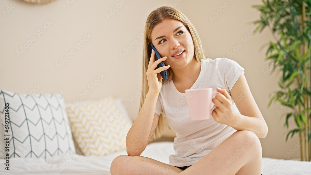 Young blonde woman talking on smartphone drinking coffee at bedroom Young blonde woman talking on smartphone drinking coffee at bedroom