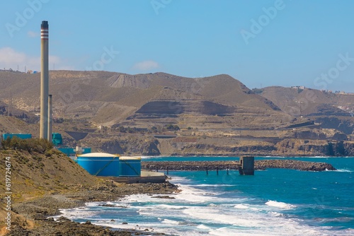 thermal power plant fueled by natural gas produces electricity. Heat generated from burning gas is converted into mechanical energy, which drives powerful generators, producing electrical power. photo