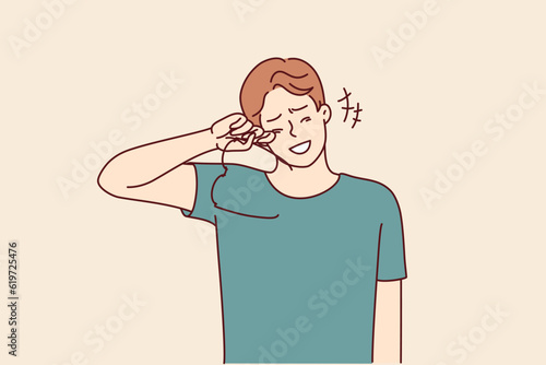 Laughing man takes off glasses wiping tears of joy from eyes after hearing joke or good news. Laughing young guy crying with happiness learning about salary increase or wife pregnancy