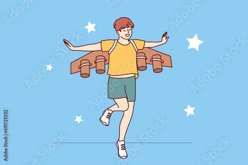 Little boy dreams of becoming pilot or astronaut and jumps in suit with airplane wings. Cheerful teenager imagines that became professional pilot and went to fly through starry sky