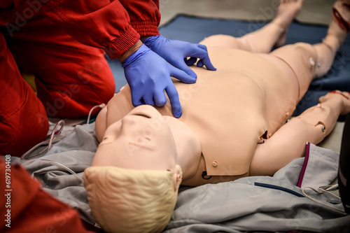 Paramedics simulate emergency intervention on medical training manikin