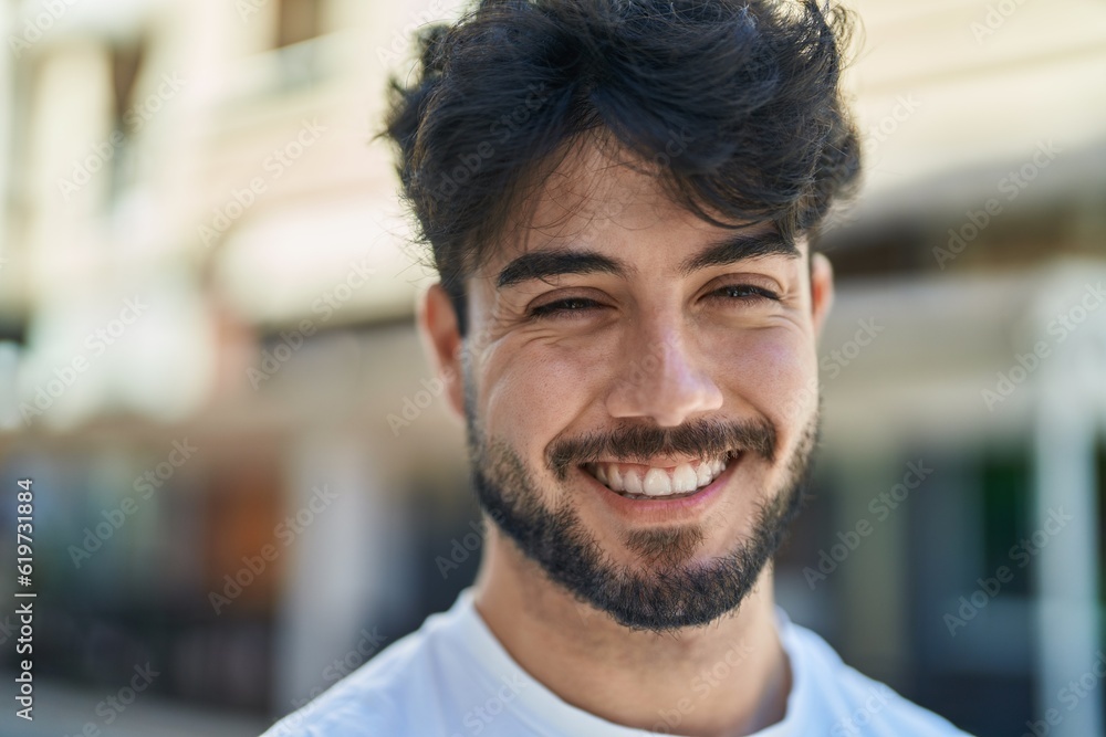 Young hispanic man smiling confident standing at street Young hispanic man smiling confident standing at street