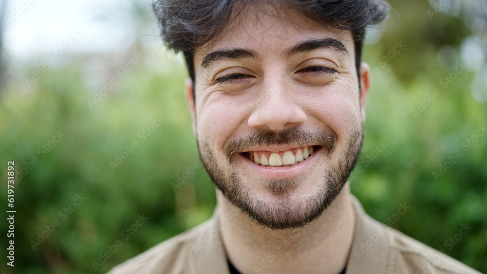 Young hispanic man smiling confident standing at park Young hispanic man smiling confident standing at park