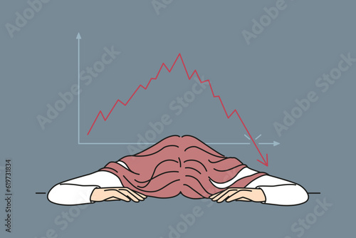 Bankrupt businesswoman put head on table near chart demonstrating crisis fall of stock market. Bankrupt woman investor upset by bad news about stock price decline or fed rate cut for lending
