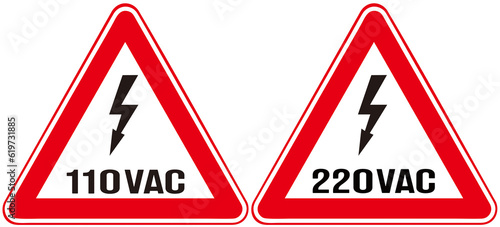 Two signs that alerts high voltage of 110v and  220v.  photo