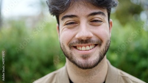 Young hispanic man smiling confident standing at park