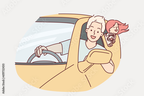 Happy family rides in car leaning out of windows to enjoy summer trip together or trip to mall