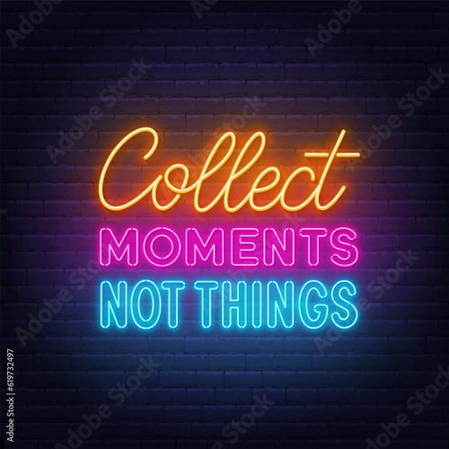 Collect Moments Not Things neon lettering on brick wall background.