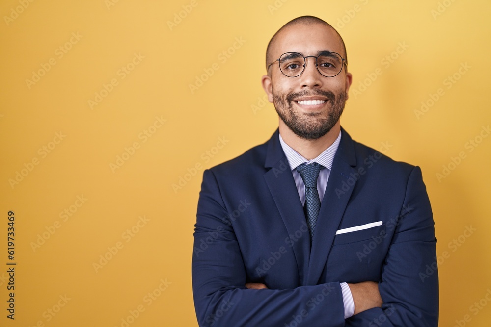 Hispanic man with beard wearing suit and tie happy face smiling with crossed arms looking at the camera. positive person. Hispanic man with beard wearing suit and tie happy face smiling with crossed arms looking at the camera. positive person.