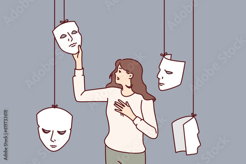 Woman actress chooses mask for performing in theater or substituting emotions to deceive interlocutor. Girl with masks, metaphor for hypocrisy and mental disorder or mental problems.