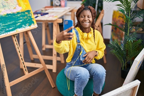 African american woman artist make selfie by smartphone at art studio © Krakenimages.com