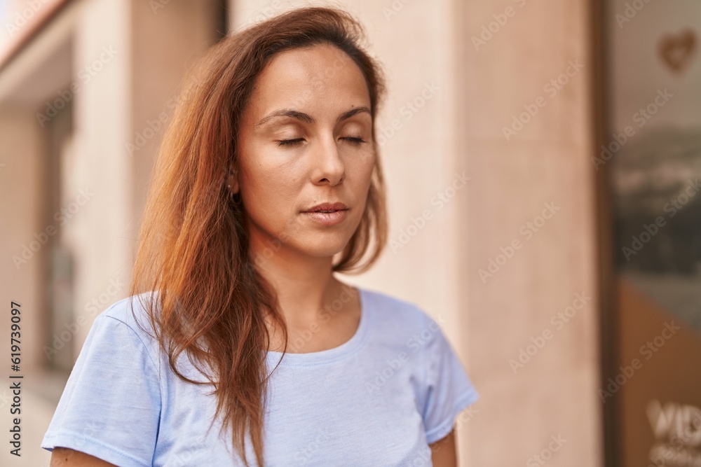 Young woman breathing at street Young woman breathing at street