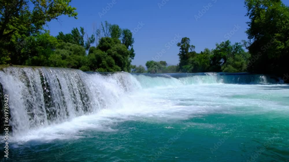 Manavgat waterfall Manavgat River is near the city of Side, 3 km north of Manavgat in Turkey. A wide stream of water falls from a low height.