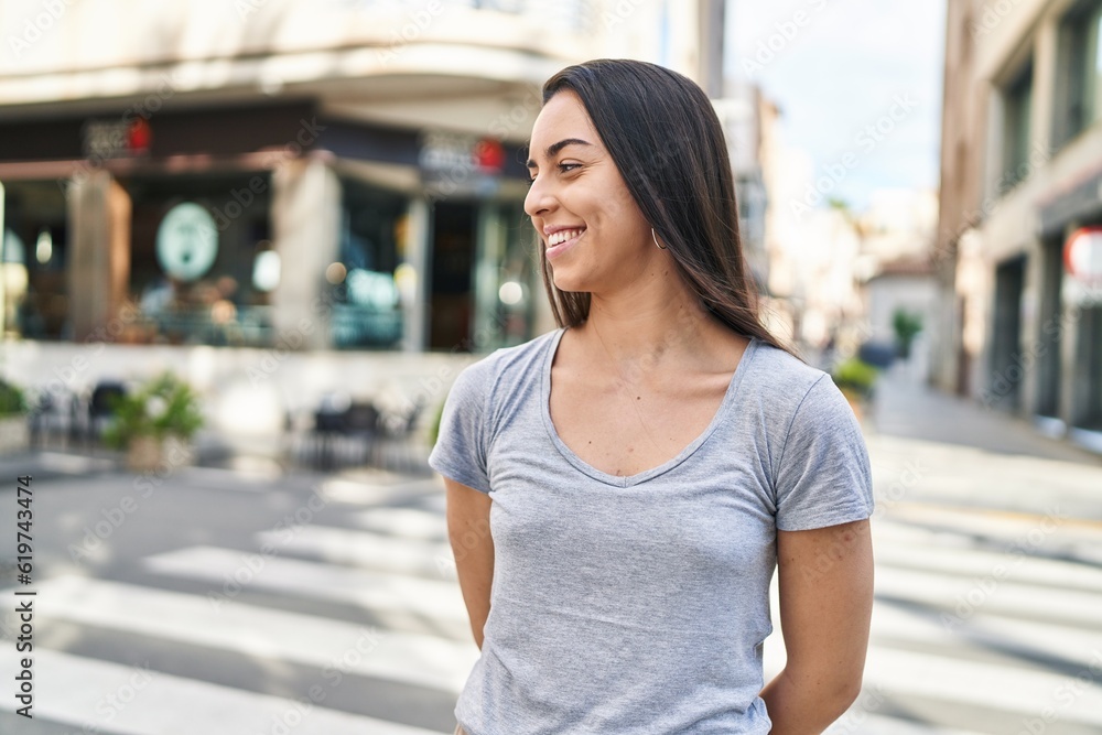 Young beautiful hispanic woman smiling confident looking to the side at street Young beautiful hispanic woman smiling confident looking to the side at street