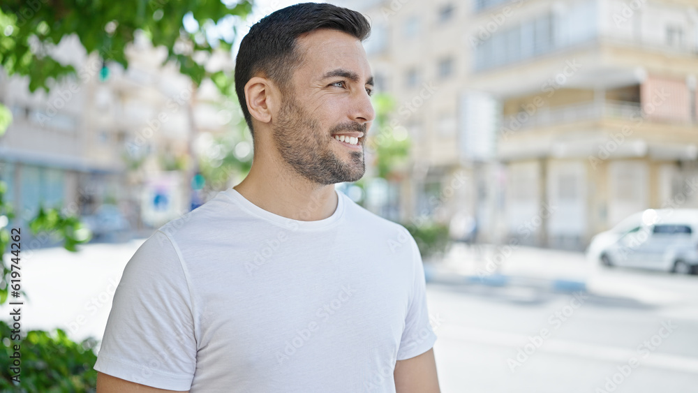 Young hispanic man smiling confident looking to the side at street Young hispanic man smiling confident looking to the side at street