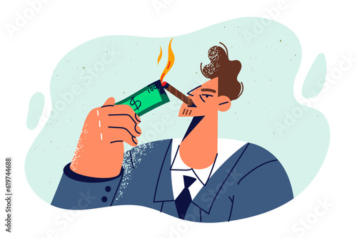 Rich man millionaire smokes cigar and sets dollar bill on fire to show lack of financial problems