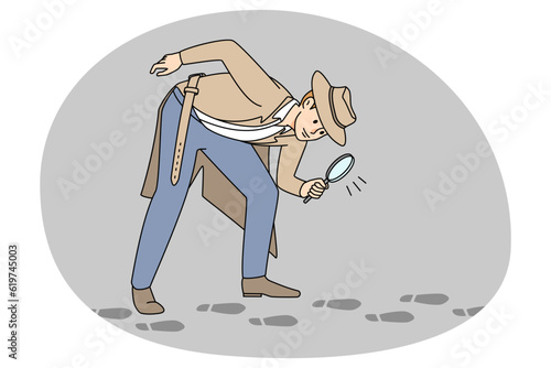 Detective with magnifier following footsteps