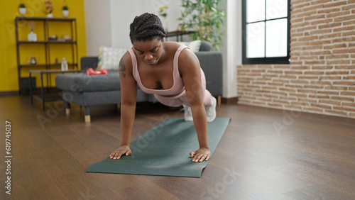 African american woman training push up exercise at home